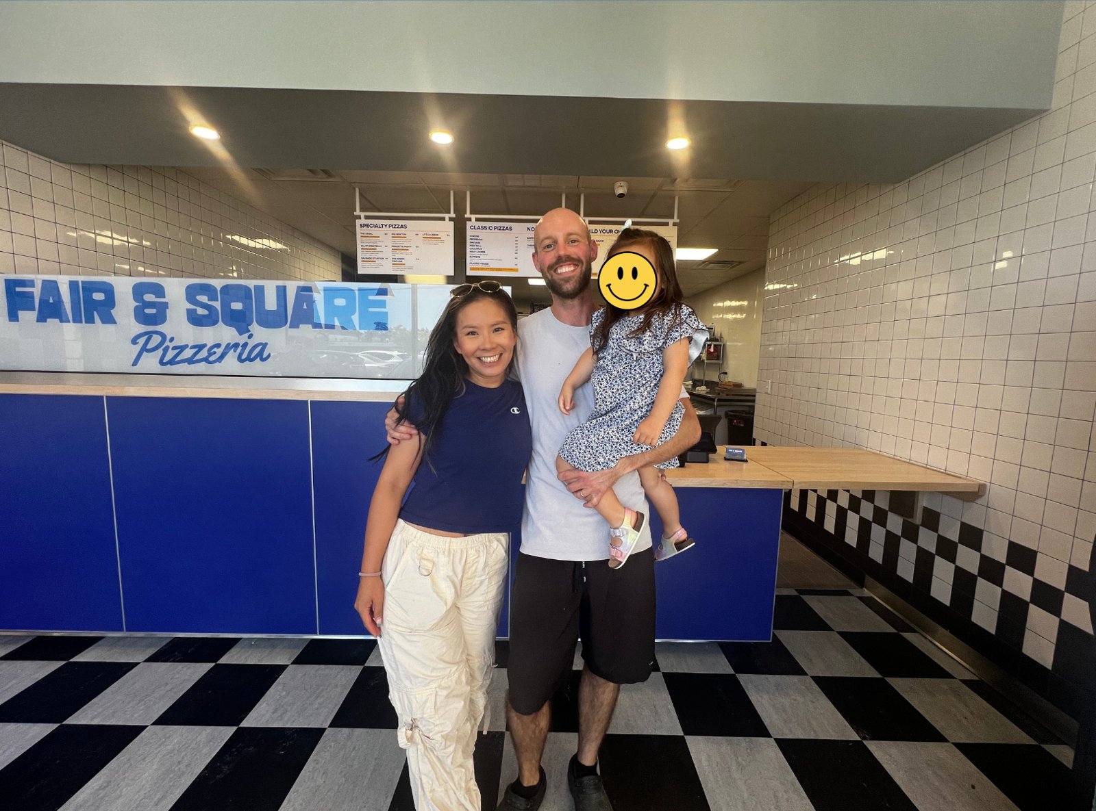 Ben and his family smiling in front of the Fair & Square counter
